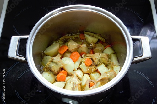 In a pot, homemade freshly cooked artichokes ala polita. Top view of a popular Greek vegan food photo