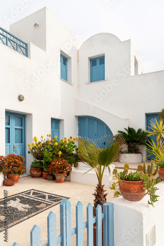 White house with blue windows and doors in Santorini, Greece