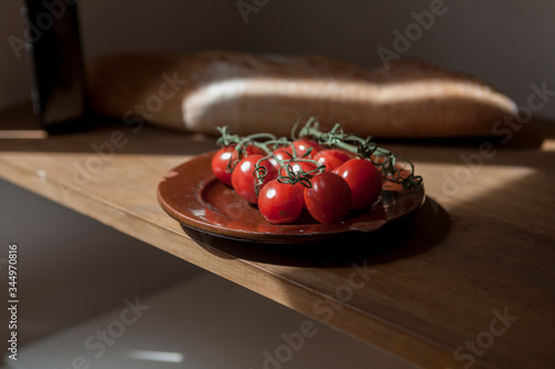 Photography Mediterranean food, bread, cherry tomato and olive oil on a table in the home ki