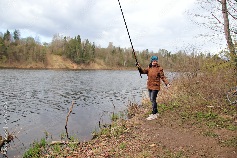 woman with fishing rod on the river woman with fishing rod on the river