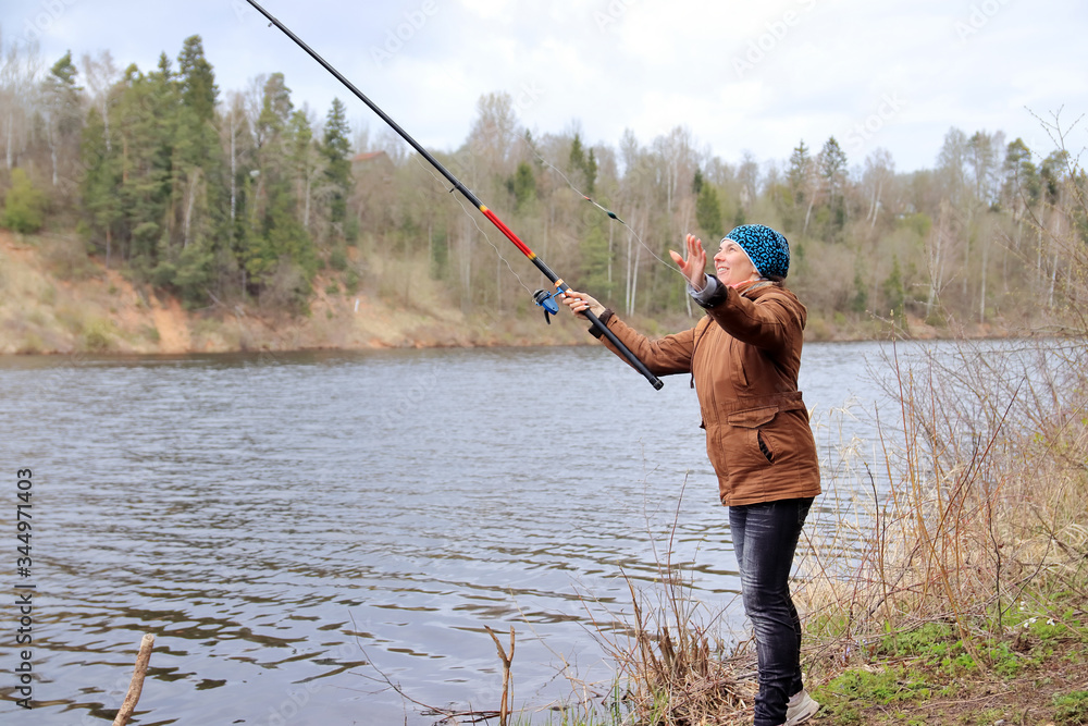 woman with fishing rod on the river woman with fishing rod on the river