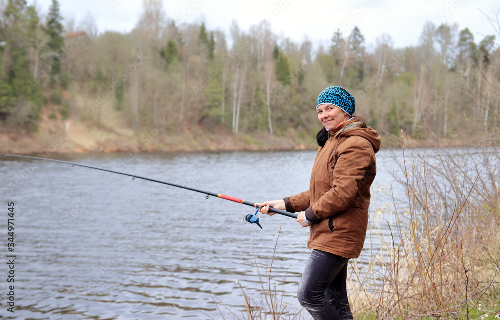 woman with fishing rod on the river woman with fishing rod on the river