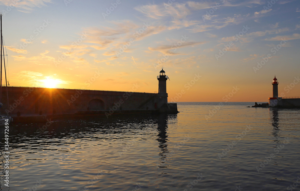 Lighthouse and sunrise , Bastia port, Corsica island.