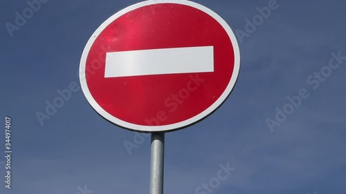 outdoor transportation sign no entry or do not pass against the blue sky background. restriction for cars and vehicles to drive