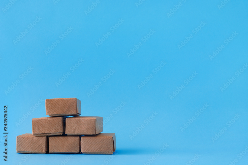 Cardboard boxes with groceries or other purchases on blue background. Cardboard boxes with groceries or other purchases on blue background.