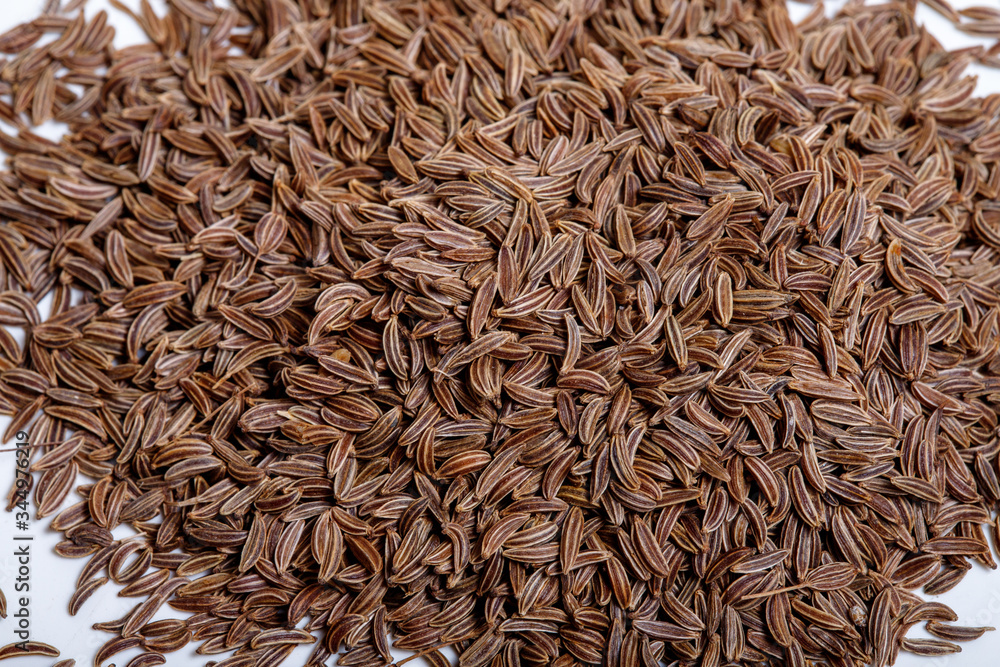 Pile of cumin seeds isolated on white background Pile of cumin seeds isolated on white background