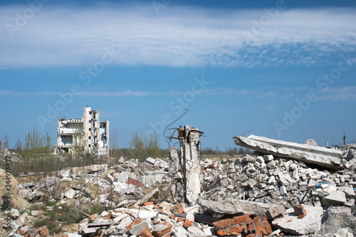 The remains of a destroyed building against a textured blue sky
