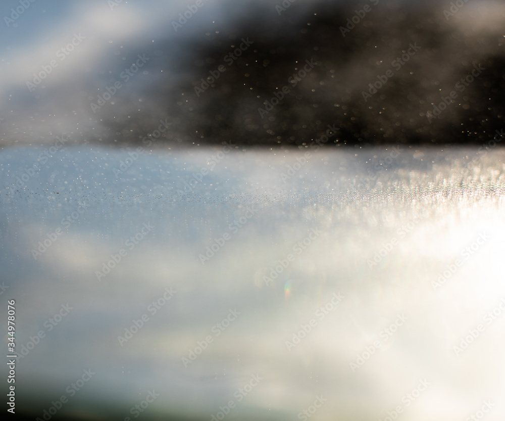 Small drops of water beaten by the sun in the counter-jour form gray abstractions Small drops of water beaten by the sun in the counter-jour form gray abstractions