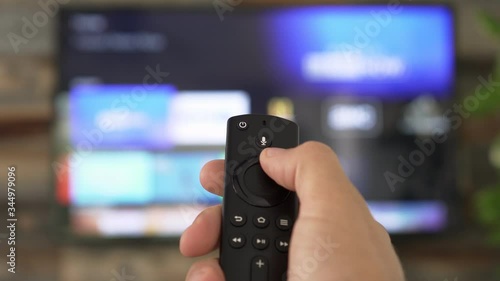 Wallpaper Mural Male hand holding the TV remote control and changing TV channels Torontodigital.ca