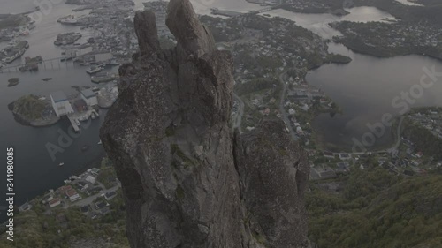 aerial drone view over a seaside town  with a mountain in the foreground 