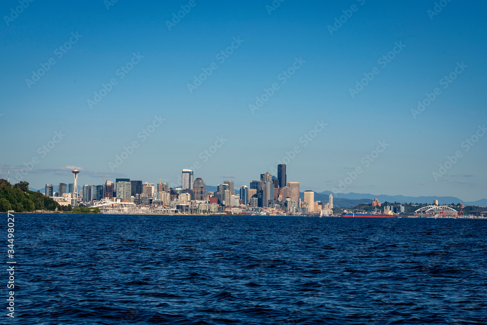The downtown Seattle skyline rises above Elliot Bay on a beautiful sunny afternoon as seen from the waters of Puget Sound.