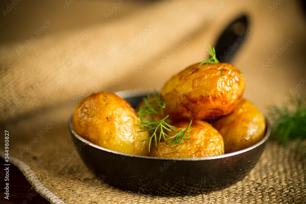 whole fried young potatoes in a pan