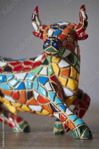 Photography Miniature multicolored statue of bull in Gaudi style, traditional souvenir from