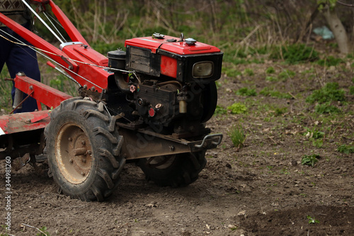 a walk-behind tractor in a field © Сергей Луговский