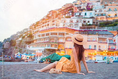 Summer holiday in Italy. Young woman in Positano village on the background, Amalfi Coast, Italy photo
