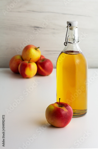 A glass bottle of apple juice, cider, vinegar