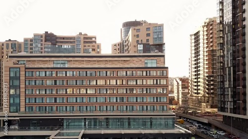 Aerial shoot with a drone of a city residential block with high apartment buildings and a hotel during a beautiful sunset