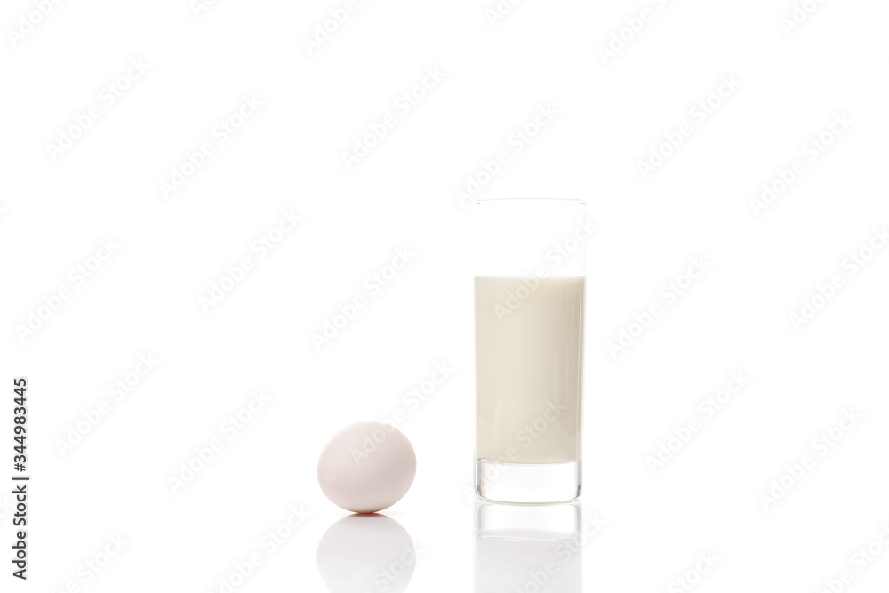A glass of pure milk and chicken egg isolated ob white background