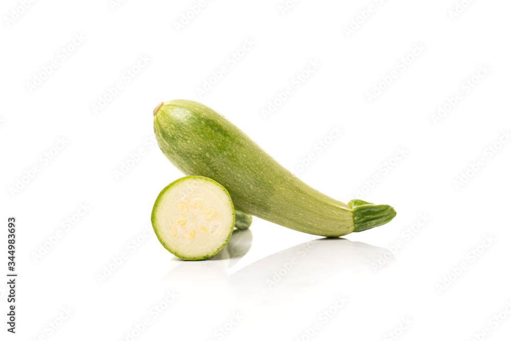 Sliced fresh zucchini, two parts of ripe vegetable on a white background Sliced fresh zucchini, two parts of ripe vegetable on a white background