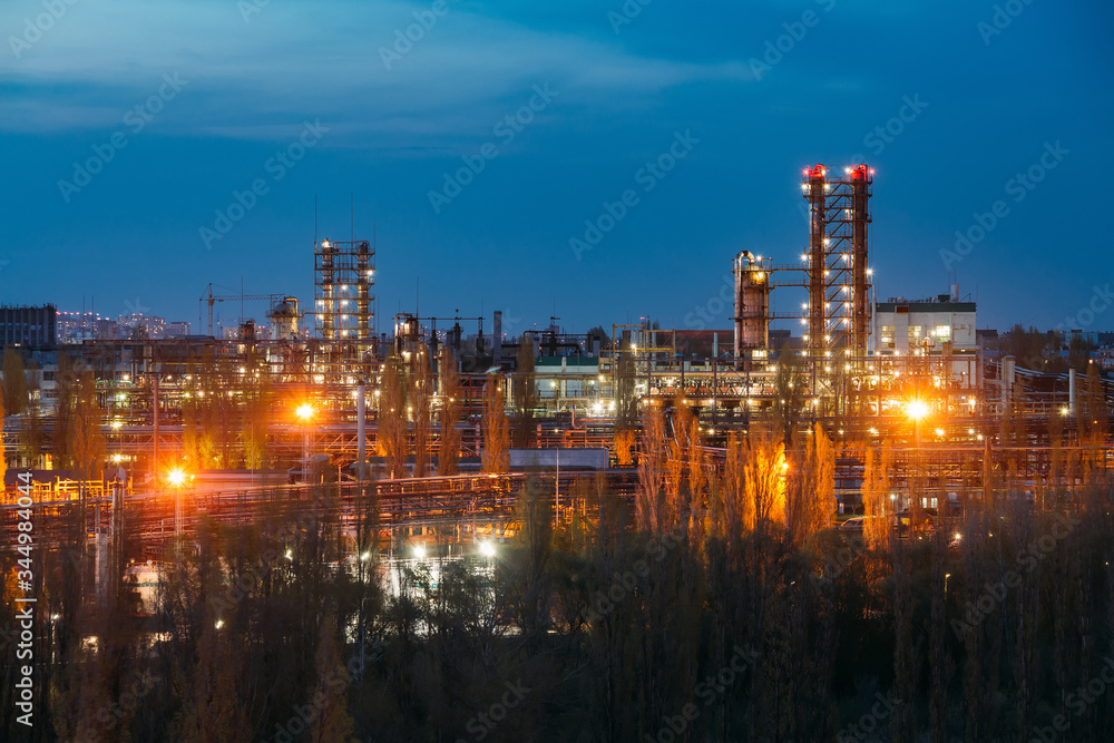 Fototapeta premium Chemical factory at summer night. Rectification towers