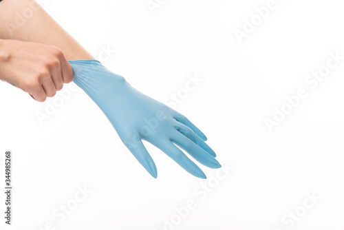 Female hand in blue glove isolated on white background © Vasya