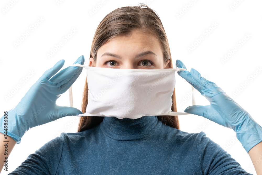 Beautiful female doctor or nurse wearing protective mask and latex or rubber gloves on white background. Beautiful female doctor or nurse wearing protective mask and latex or rubber gloves on white background.