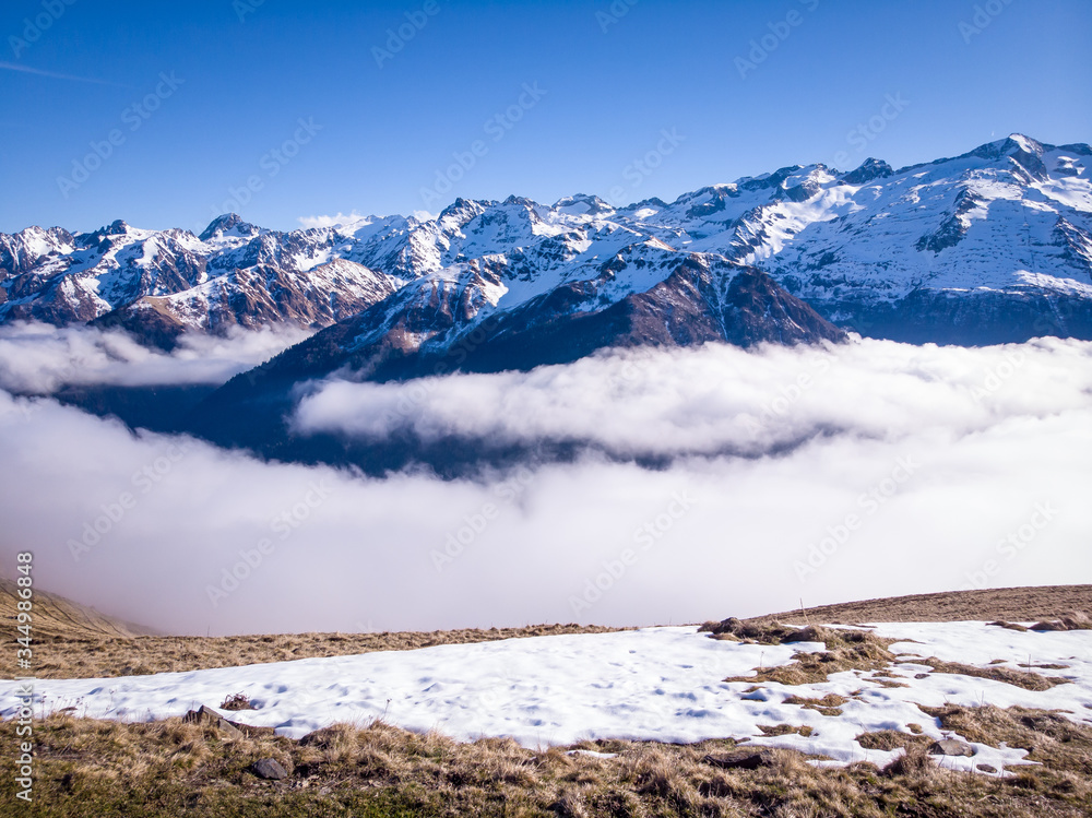 Snow and mountain peaks in the french Pyrenees near the Luchon Superbagnères Ski in Saint-Aventin, France. The Luchonnais Mountains aerial view.