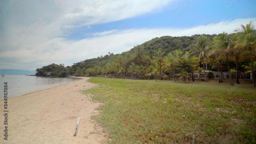 Scenic view of landscape by beach against sky, trees on land by sea - Ilhabela, Brazil
