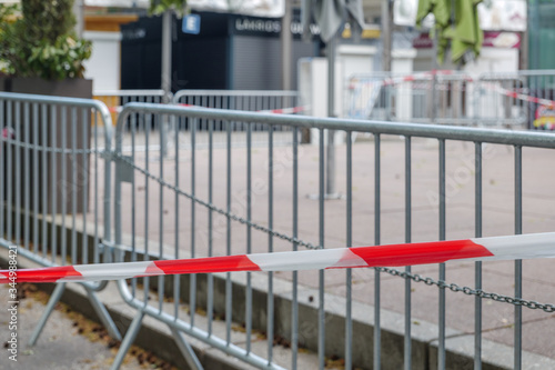 Selected focus at Red and white caution tape restrict outdoor eating area of cafe and restaurant which closed during epidemic of COVID-19 virus. COVID-19 restrictions on restaurant business in Europe.