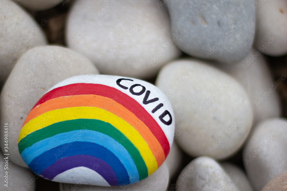 Painted rock with a rainbow and COVID text
