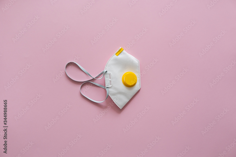 Respirator mask FFP or dust mask to cover the mouth and nose prevent coronavirus isolated on pink background. Breathing protection against air pollution, flu and coronavirus. Respirator mask FFP or dust mask to cover the mouth and nose prevent coronavirus isolated on pink background. Breathing protection against air pollution, flu and coronavirus.