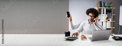 Multitasking Businessman In Office photo