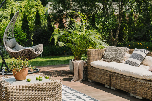 Elegant garden furniture on terrace of suburban home photo