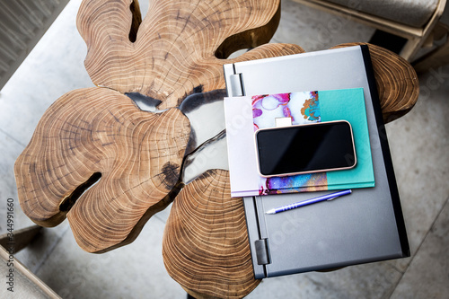 Laptop, diary, phone and pen on a wooden table