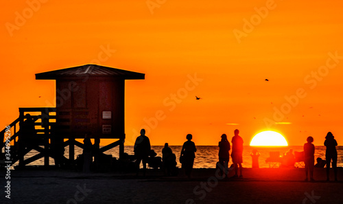 sunset at the beach, silhouette, sky, sun, orange, lifeguard, dusk, evening, ocean, horizon, sea, 