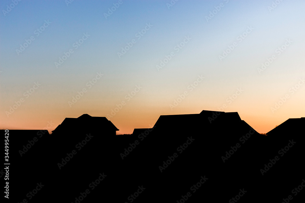Silhouette of Houses at Sunset