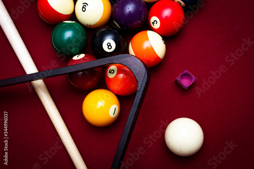 Billiard balls on a red felt pool table