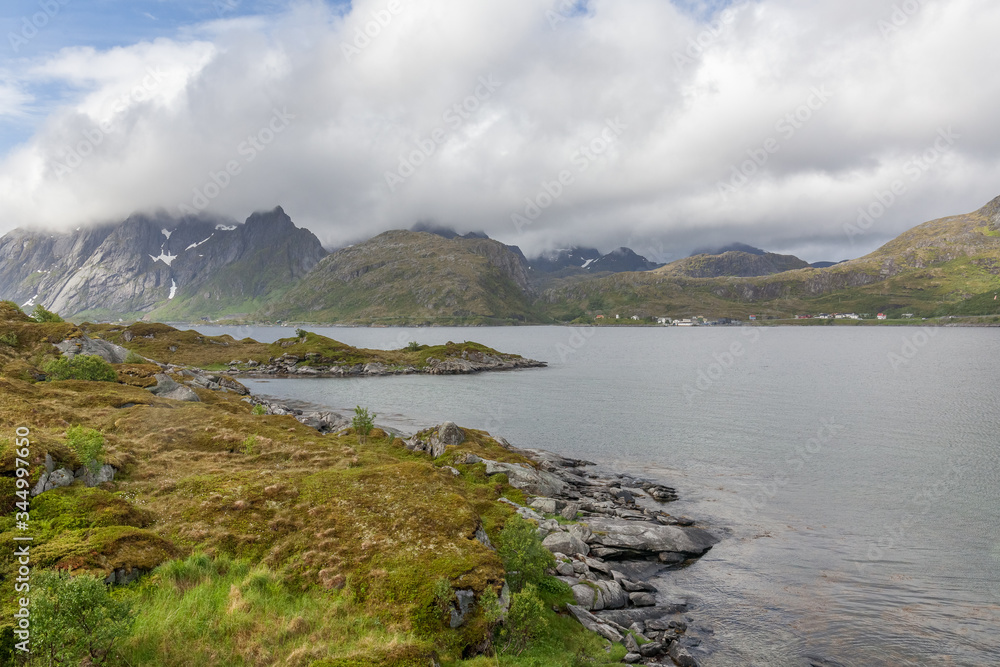 Fototapeta premium End of fjord. Beautiful Norwegian landscape. view of the fjords. Norway ideal fjord reflection in clear water In cloudy weather. selective focus
