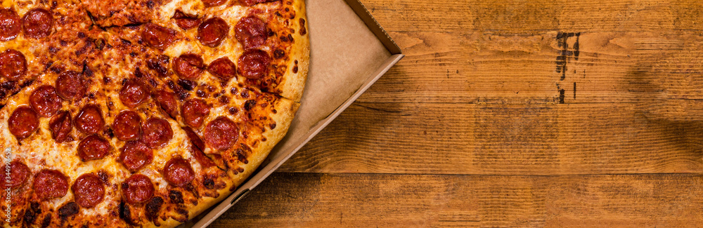 Pepperoni Pizza on Wooden Background. Selective focus. Pepperoni Pizza on Wooden Background. Selective focus.