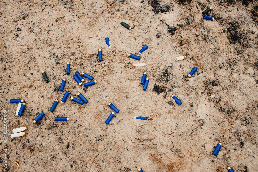 used ammunition cartridges on a soil. 12 mm. background