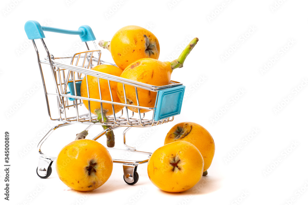 loquat fruit in shopping cart with white background
