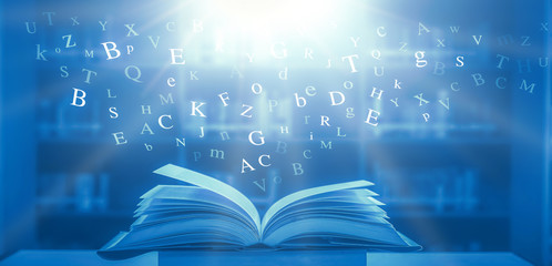 The concept of education by planting a tree of knowledge in the opening of an old book in the library and the magical magic of light that flies to the destination of success. Beautiful background