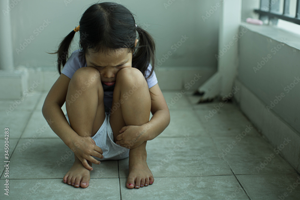 Fototapeta premium Depressed sad child sitting alone at home.