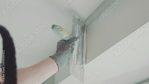 male puttying a window opening. close up, portrait