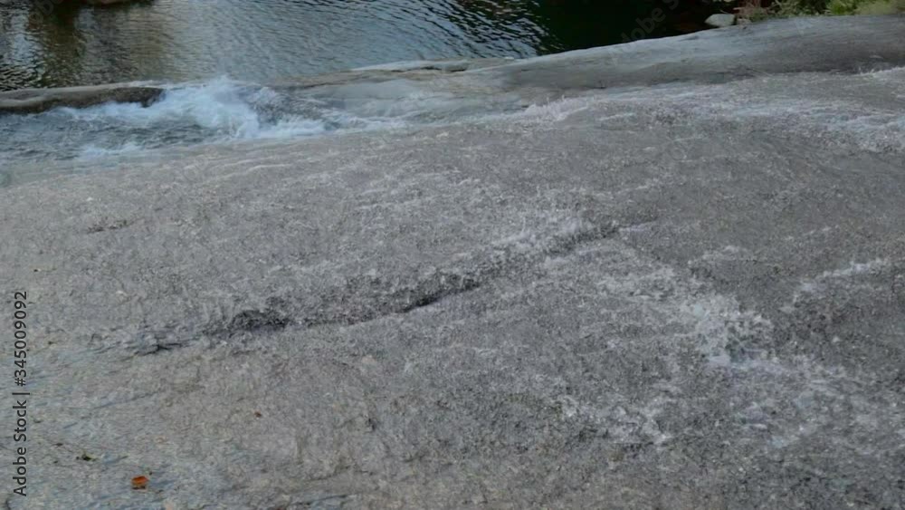 High angle view of flowing water on rocks over river - Ilhabela, Brazil High angle view of flowing water on rocks over river - Ilhabela, Brazil