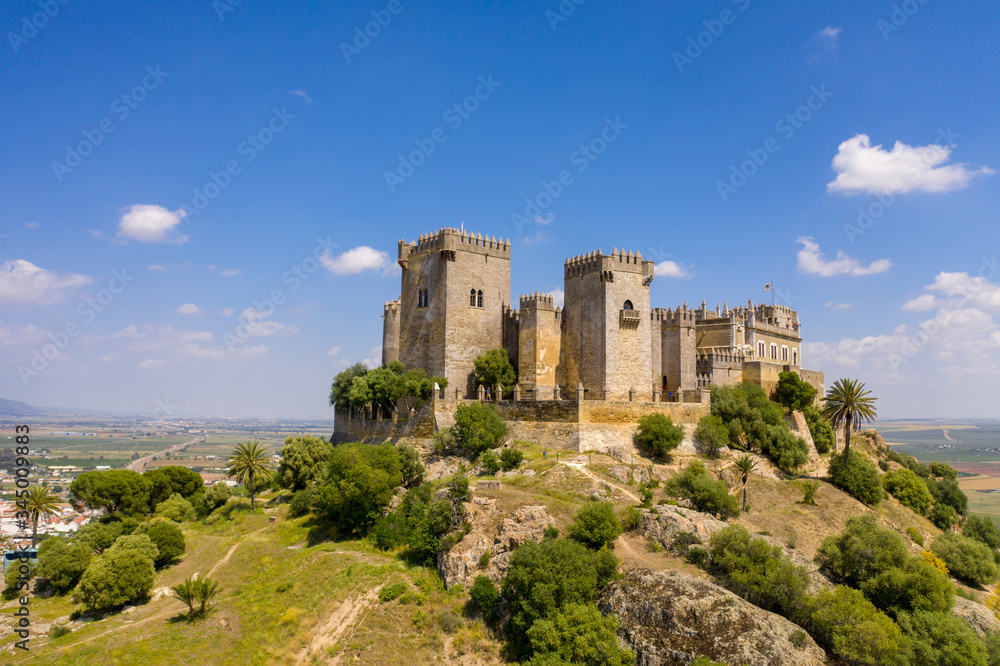 Aerial Drone view of a beautiful castle in South of Spain with green fields in the background