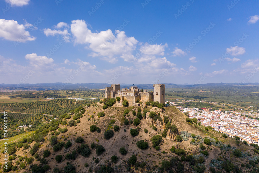 Aerial Drone view of a beautiful castle in South of Spain with green fields in the background