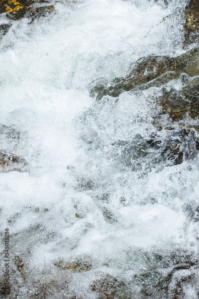 Rapid flowing water in mountain river stream. Foam flow water splash natural waterfall wild nature background
Rapid flowing water in mountain river stream. Foam flow water splash natural waterfall wild nature background