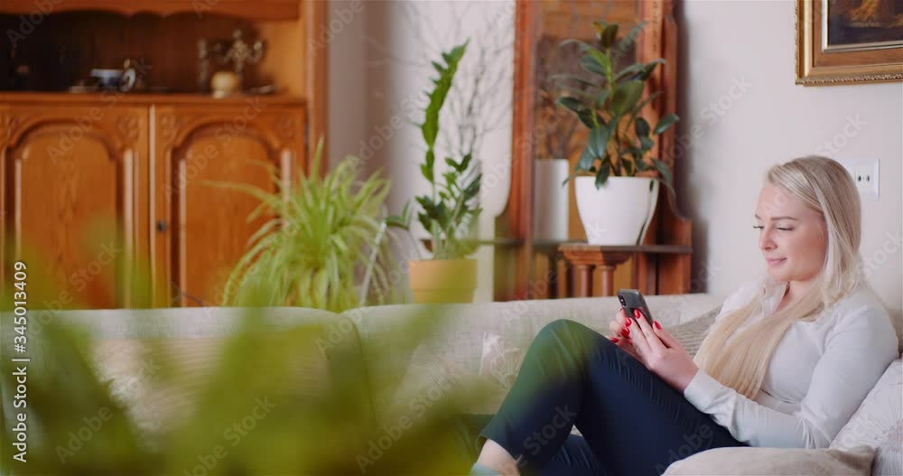 Businesswoman Using Mobile Phone On Sofa Businesswoman Using Mobile Phone On Sofa