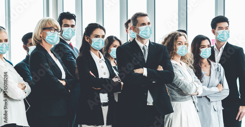 Confident business people with face mask protect from Coronavirus or COVID-19. Concept of help, support and collaboration together to overcome epidemic of Coronavirus or COVID-19 to reopen business. photo